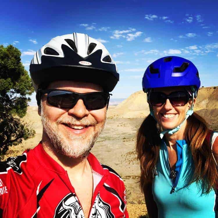 Kenny and April smiling and posing in their mountain biking gear in North Fruita Desert Colorado