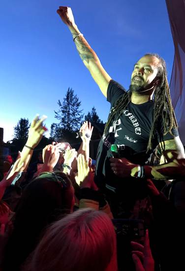 Michael Franti with his fist raised - a sign of happiness and his concerts are how I find my happy