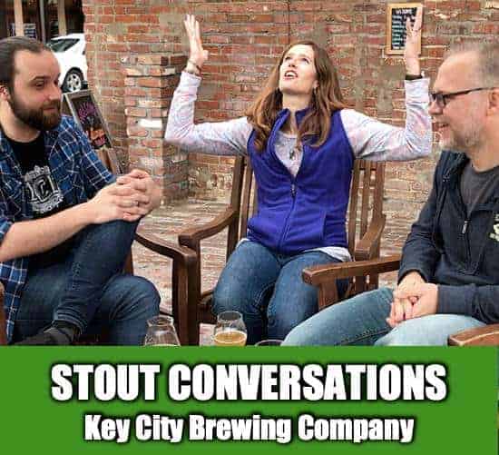 April with her hands in the air with Ken and Zack at Key City Brewing in Vicksburg Mississippi