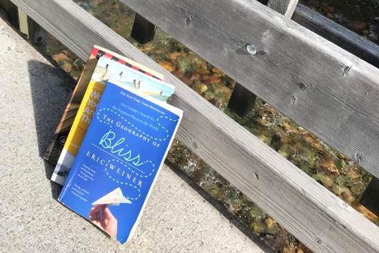 How to find happiness - three books on this subject sitting on the sidewalk