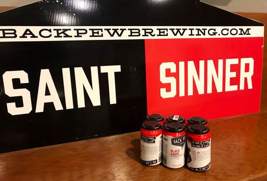 Back Brew Beer set in from of church pew at Back Pew Brewing sinner vs saints sign