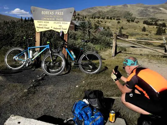 Kenny taking pictures of beer and biking at Boreas Pass Colorado