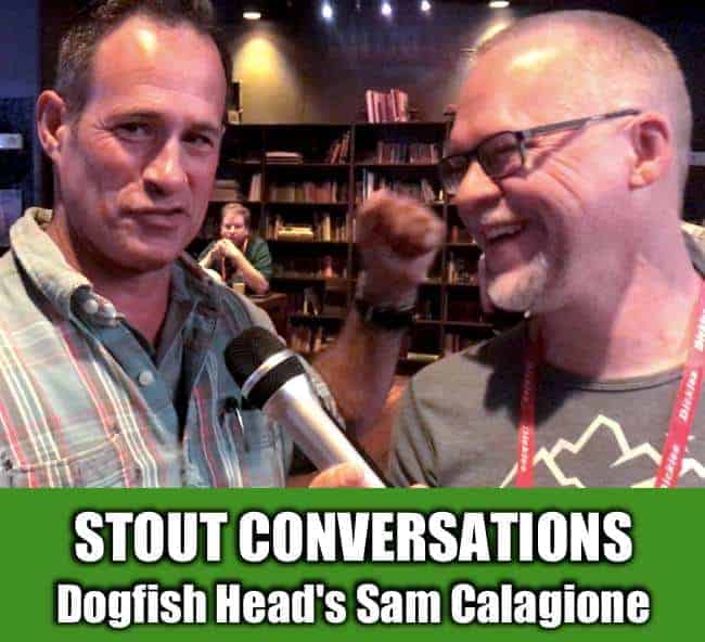Sam Calagione and Ken smiling at an interview with Ken holding a microphone at GABF at Lucky Strike Denver