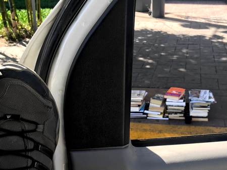 books on the sidewalk after border agents made us take them out of the RV