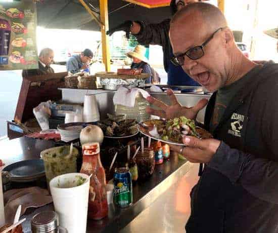 Ken at La Guerrerense with his plate full of seafood at the famous street food stand in Ensenada Baja