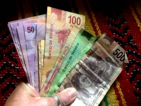 a handful of pesos - Mexican money