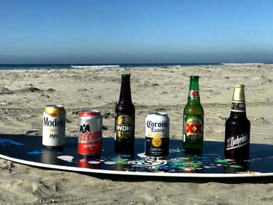 Mexican Beer Throwdown with Modelo, Tecate, Indio, Corona, Dos Equis, and Bohemia all on a boogie board on a beach