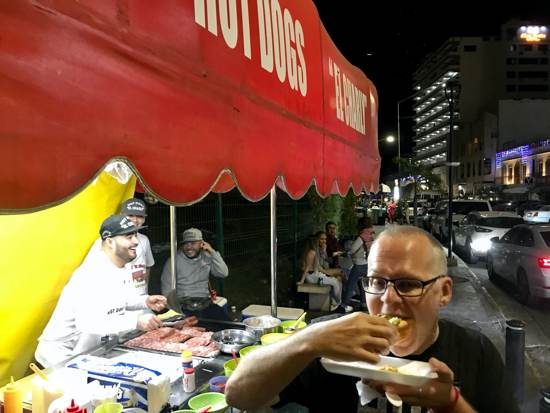 Ken eating hot dogs Mazatlan street food at Charlys