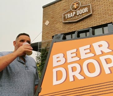 Brain and his Beer Drop Sign for his craft beer delivery business