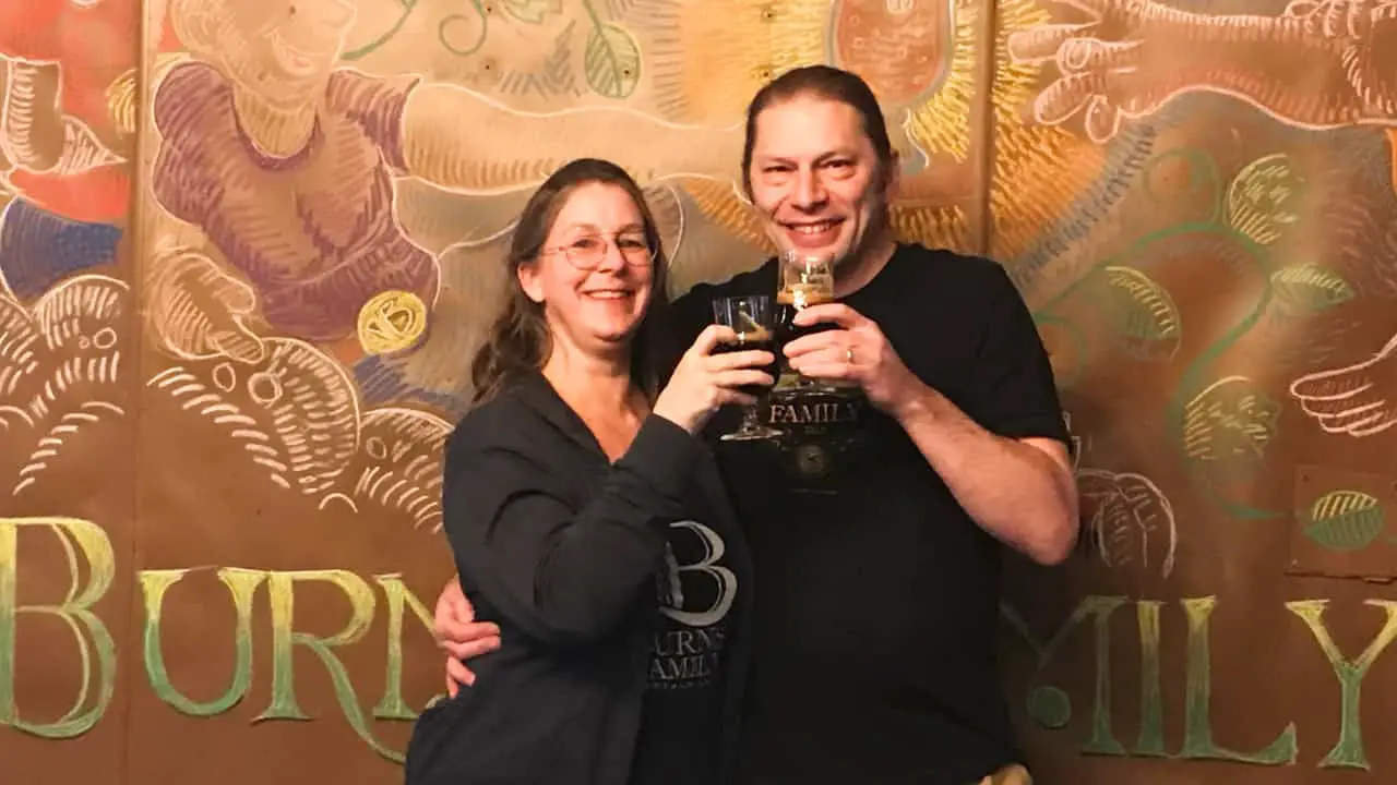 Laura and Wayne Burns Family Artisan Ales Denver Colorado holding high ABV beer