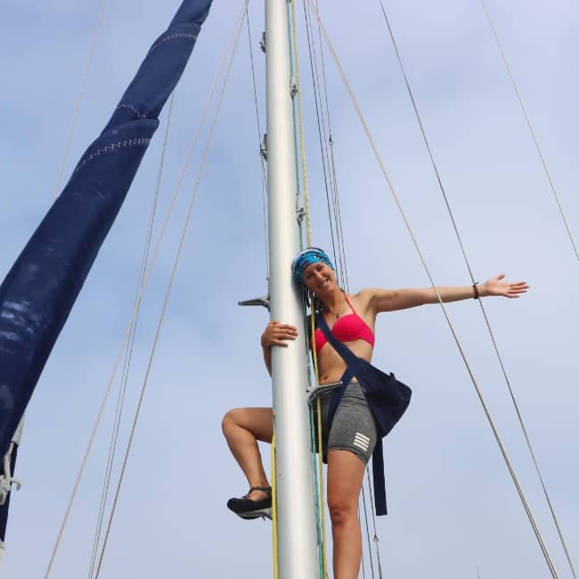Danielle making repairs up the mast Sailing Pivo New Zealand full time sailing