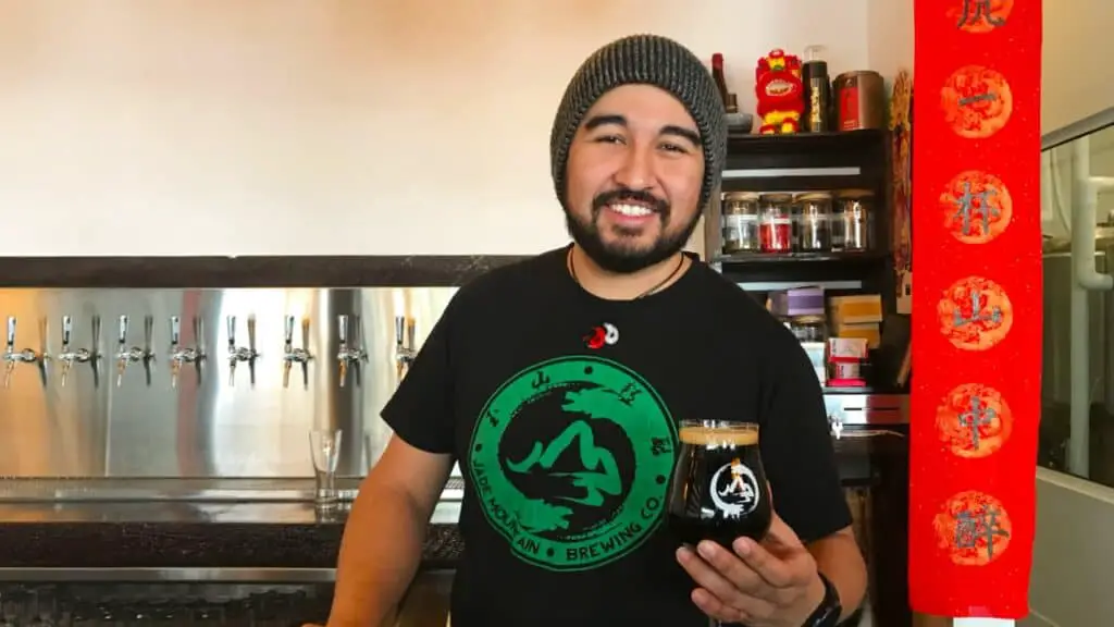 Sean Guerrero holding beer at Jade Mountain Brewing Colorado