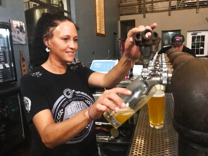 Molly pouring beer at Bootleg Brewers Nebraska