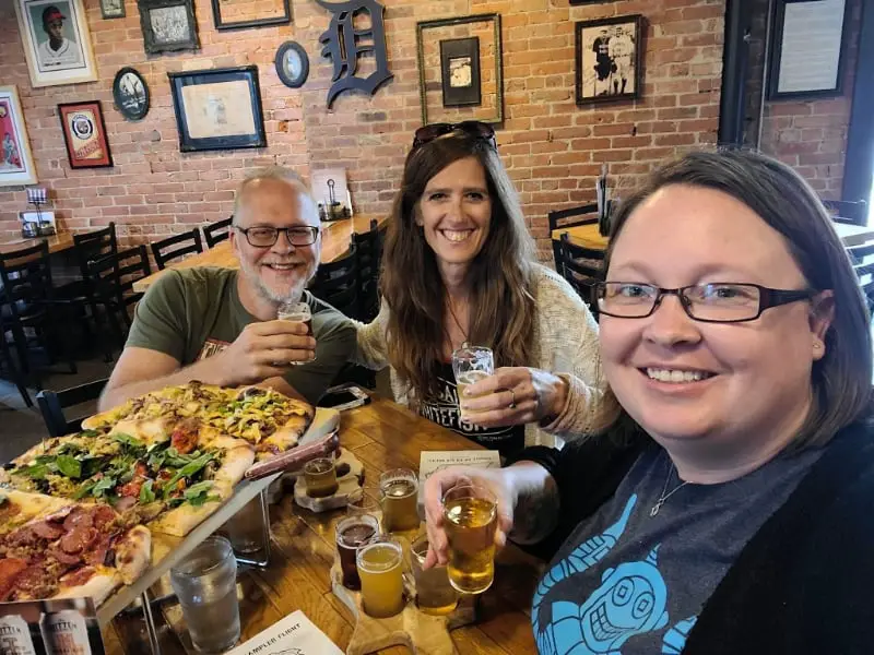 friends with pizza and beer brewery hopping Grand Rapids Michigan The Mitten