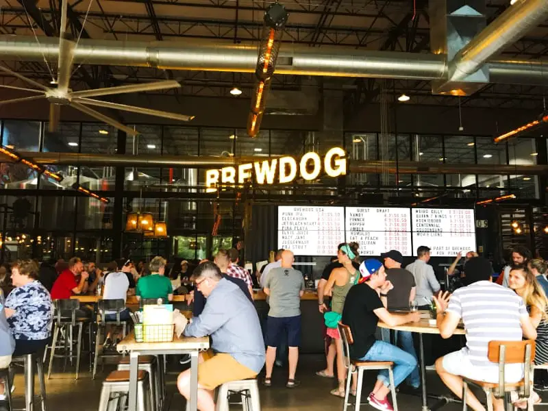 BrewDog taproom with people and beer signs