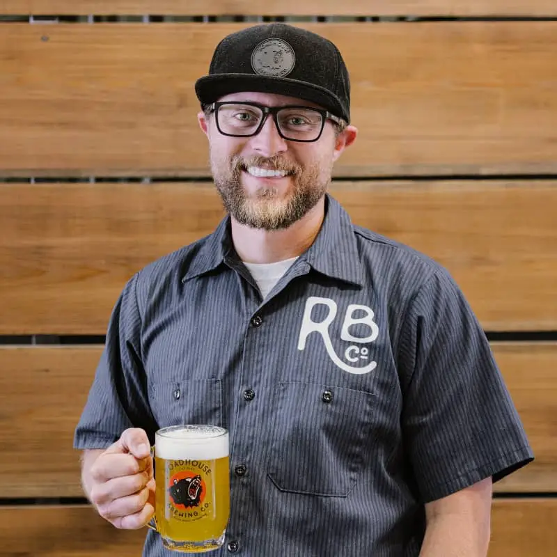 Jon Courtois holding beer at Roadhouse Brewing Sustainable brewery Wyoming