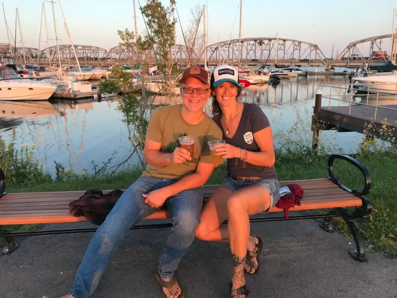 Ken and April Sturgeon Bay dock with beer from Door County Cover Ken at Door County breweries Michigan
