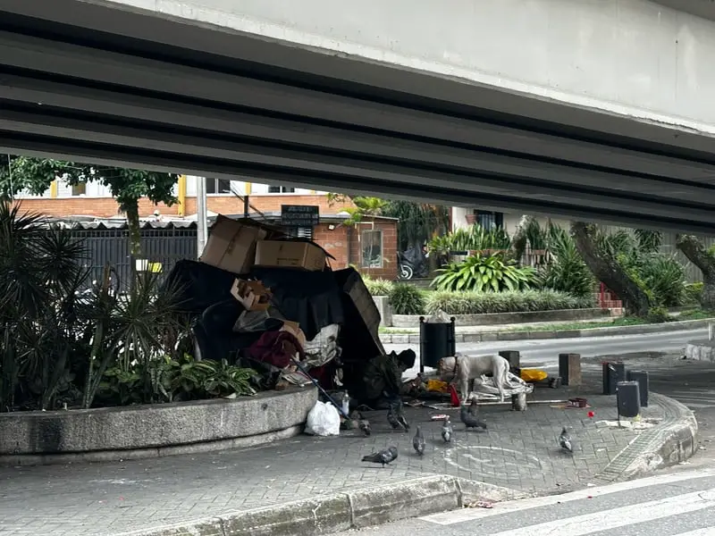 trash under a bridge in Medellin