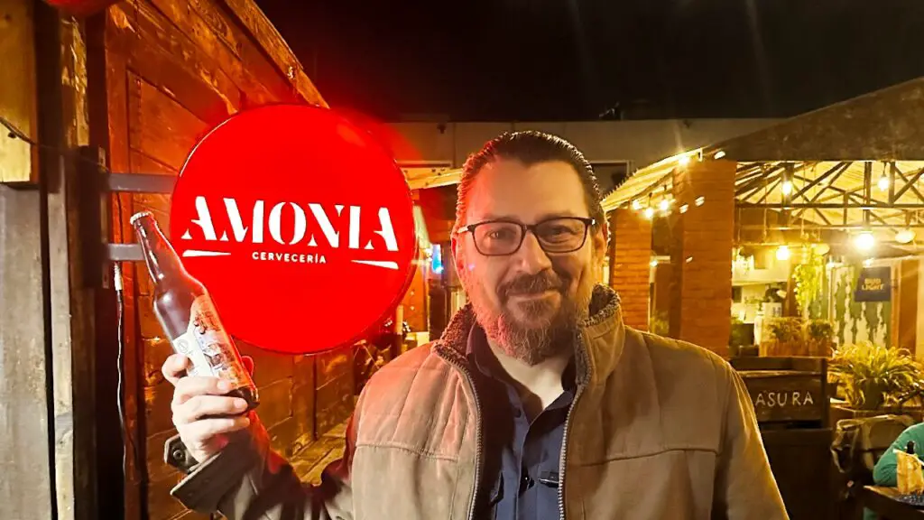 Nico in front of Amonia Cerveceria sign La Paz craft beer bar